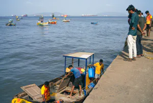 People looking down at the boat after it landed on the shore