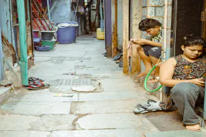 People looking at their phones in an alley