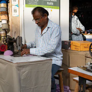 Man controling the sewing machine