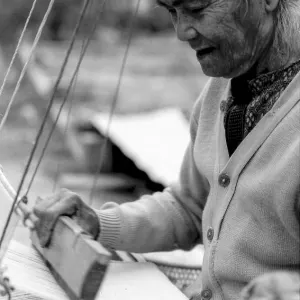 Older woman weaving