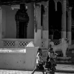 Two girls walking in front of Buddhist temple