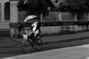Woman riding bicycle with sunshade