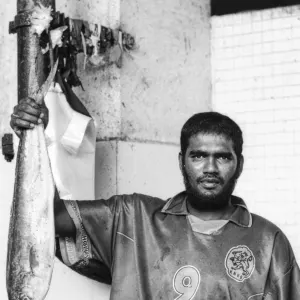 大きな魚を持ち上げる男