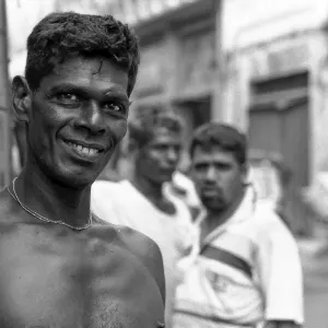 Shirtless man standing by wayside