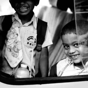 Two boys looking through car window