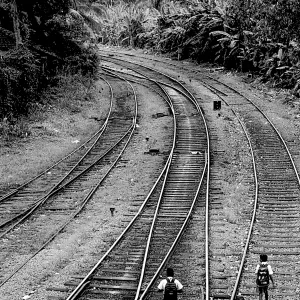 school boys walking on railway track