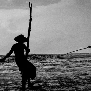 Men doing stilt fishing