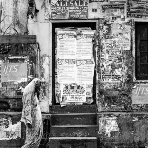 Woman with a saree in front of boarded-up door