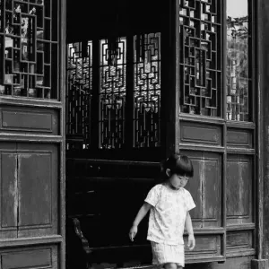 Girl coming out of Yu Garden building