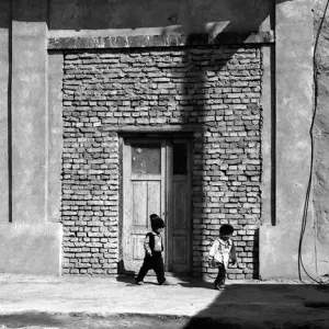 Two kids playing in old town