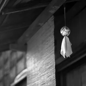 Doll hung under eaves