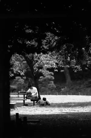 Parent and children relaxing in park