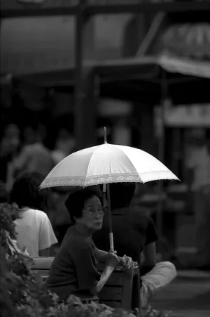 Older woman holding umbrella