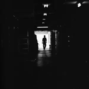 figure in the dark passageway