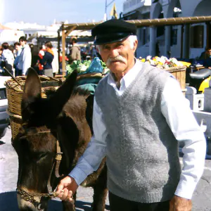 Man with a gorgeous mustache and his donkey