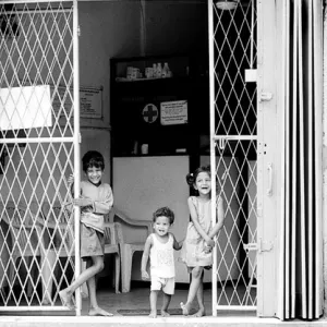 Three kids standing at gate