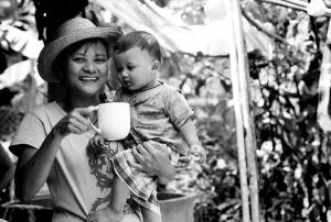 Mother holding mug and baby