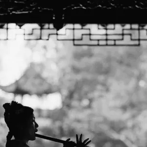 Silhouetted Woman playing flute