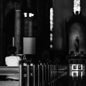 Worshiper in dim Manila cathedral