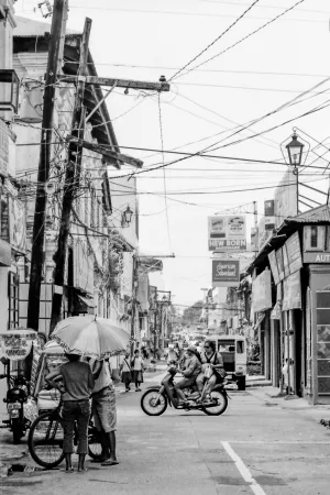 Two persons standing under same umbrella