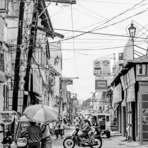 Two persons standing under same umbrella