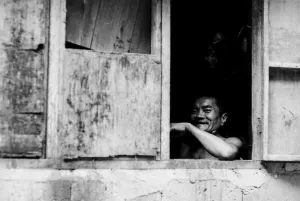 Man smiling by window