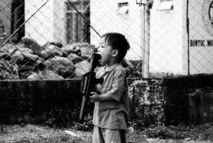 Boy holding gun in mouth