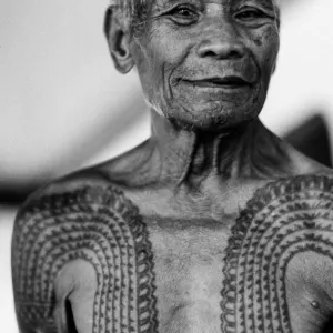 Old man showing tattooed chest