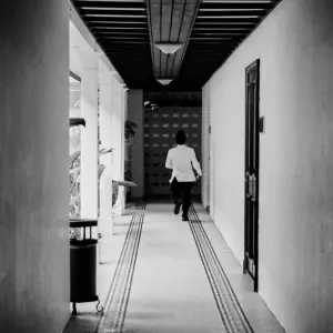 Hotel employee running corridor
