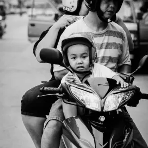 Family riding on same motorbike