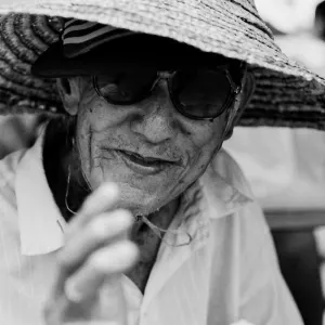 Man wearing straw hat and sunglasses