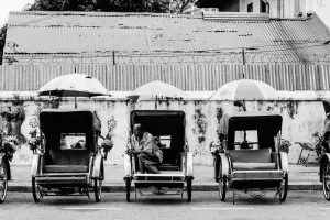 Many trishaws parked by roadside