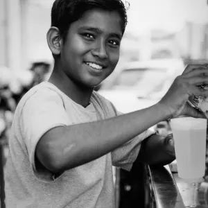 Boy making fresh juice happily