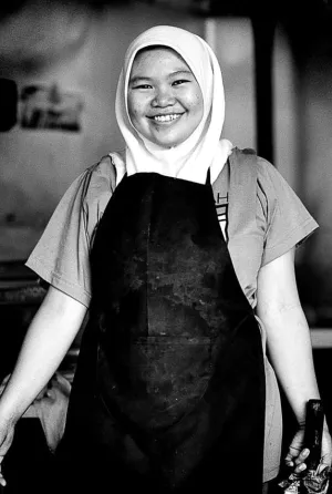 Smiling girl wearing apron