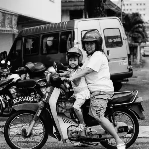 Mother and daughter riding on same motorbike