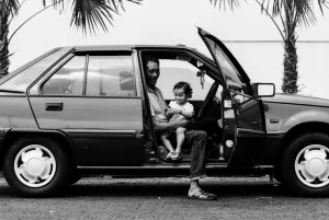Father and little daughter sitting in car