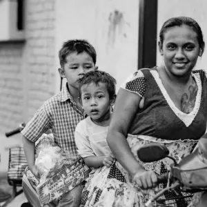 Mother and two sons riding on same motorbike
