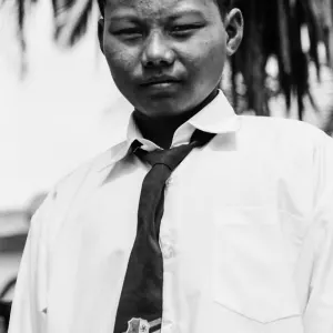 Boy wearing school uniform and songkok