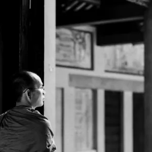 Buddhist monk standing at door