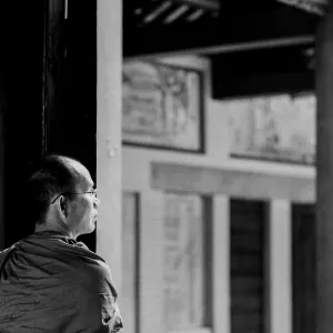 Buddhist monk standing at door