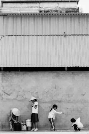 Four persons standing against wall
