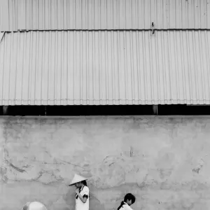 Four persons standing against wall
