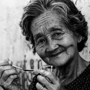 Older woman holding spoon