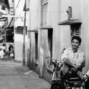 Man holding legs on motorbike