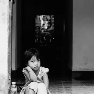Little girl sitting at entrance