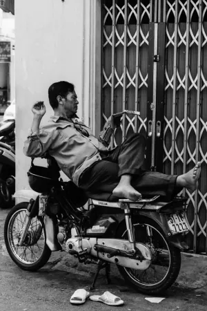 Man reading magazine on motorbike