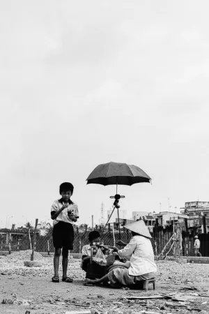 Street vendor working under umbrella