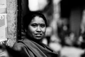 Woman sitting in corner of street