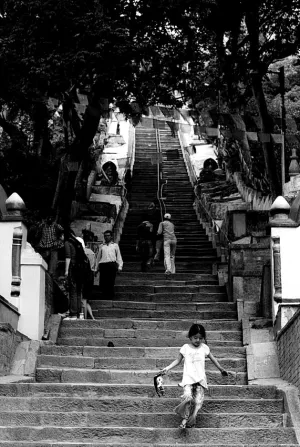 Girl descending steep stairway