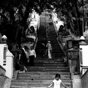Girl descending steep stairway